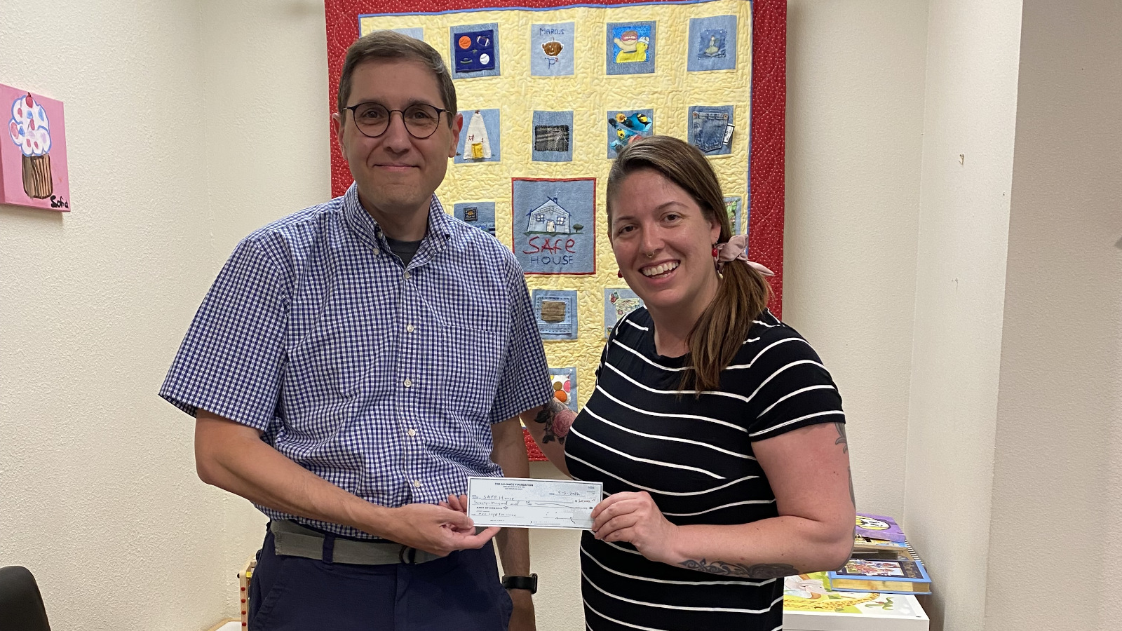 Brad Barrie from Alliance Foundation presenting a check to Beth Flory from S.A.F.E. House.